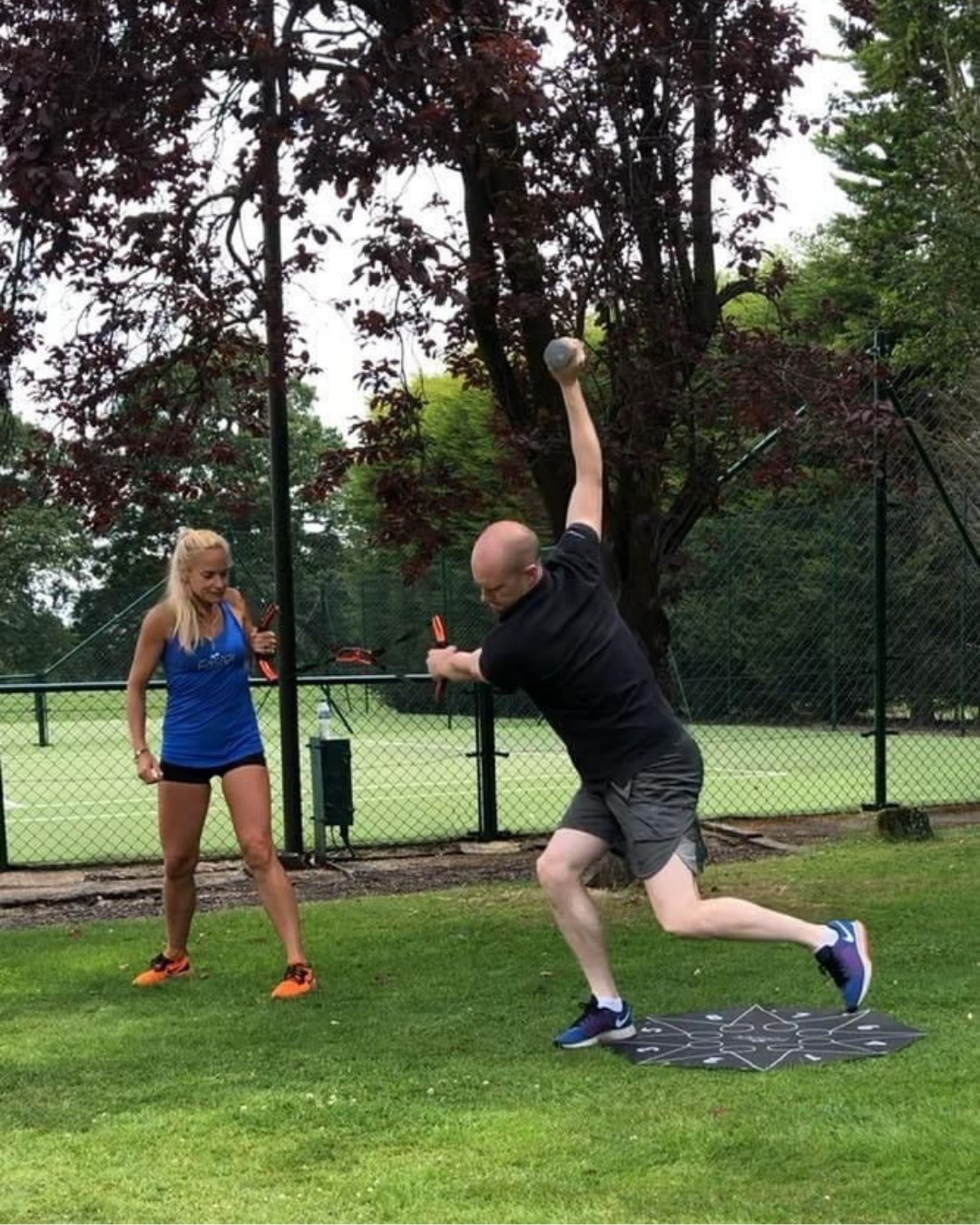 A sprint start on a tennis court, a training partner cheering